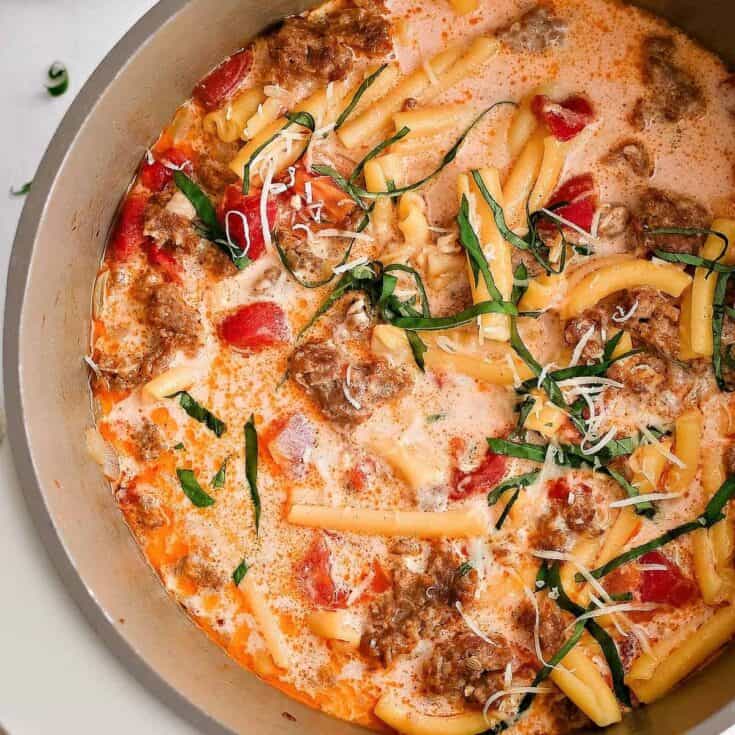 Creamy tomato pasta with ground beef, fresh basil, and shredded cheese.