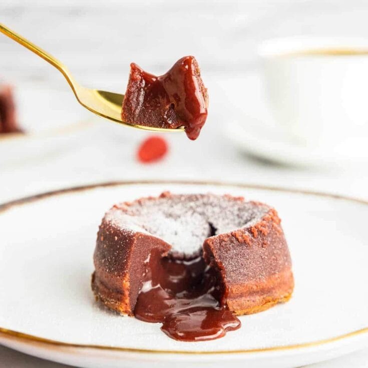 Rich molten chocolate lava cake with melted center and dusted powdered sugar.