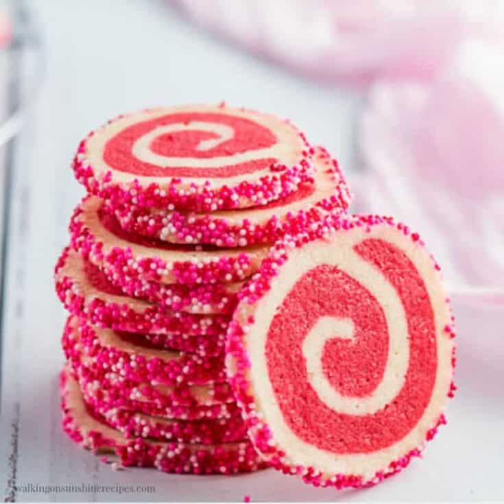Colorful peppermint swirl cookies with pink sprinkles, perfect for holiday treats.