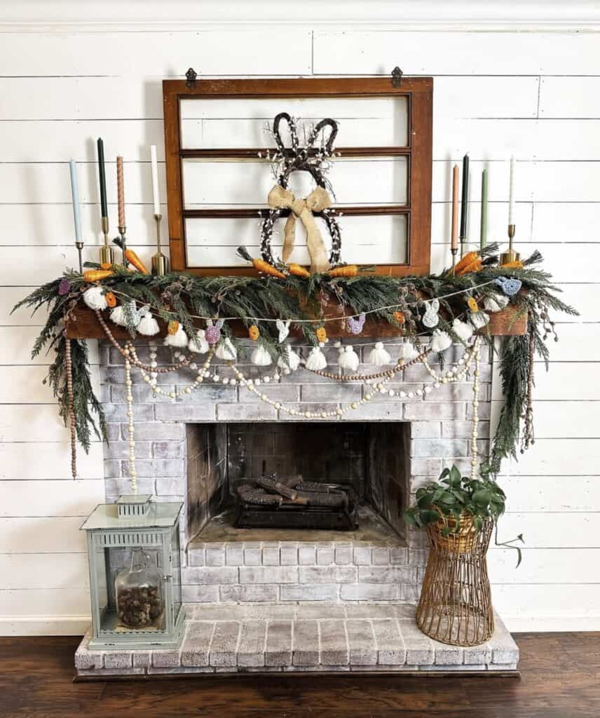Decorative fireplace mantel with Christmas garland, candles, and farmhouse style wreath.