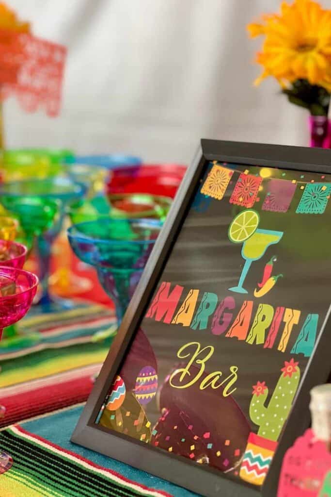 Colorful margarita bar sign with vibrant decorations and fiesta elements.