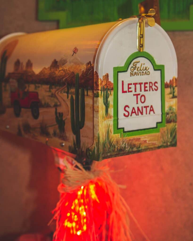 A mailbox with a christmas light in front of it