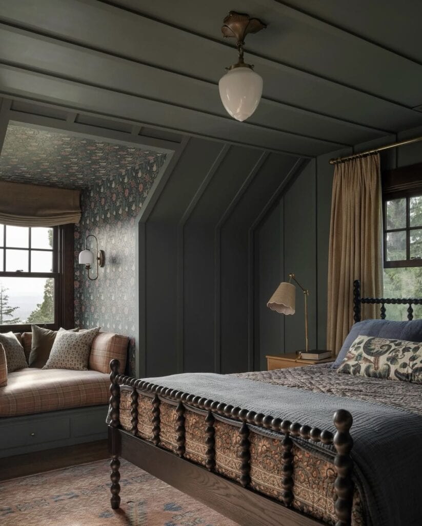 Cozy bedroom with dark green paneled walls, vintage bed, and floral accents at The Olive Branch Nest.