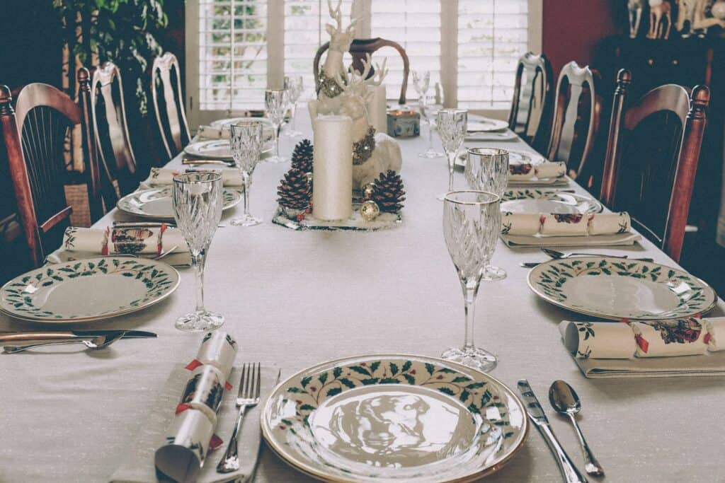 Elegant holiday dining table with festive place settings and Christmas decorations.