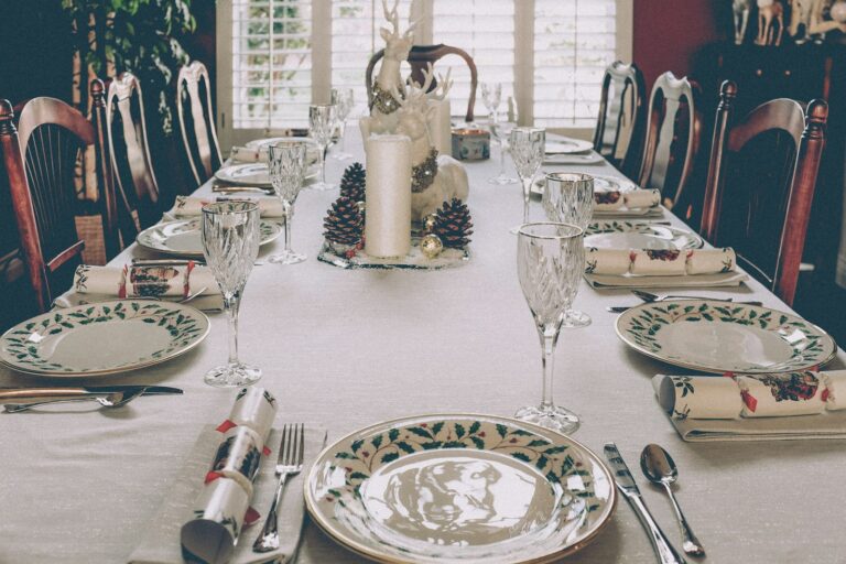 Elegant holiday dining table with festive place settings and Christmas decorations.