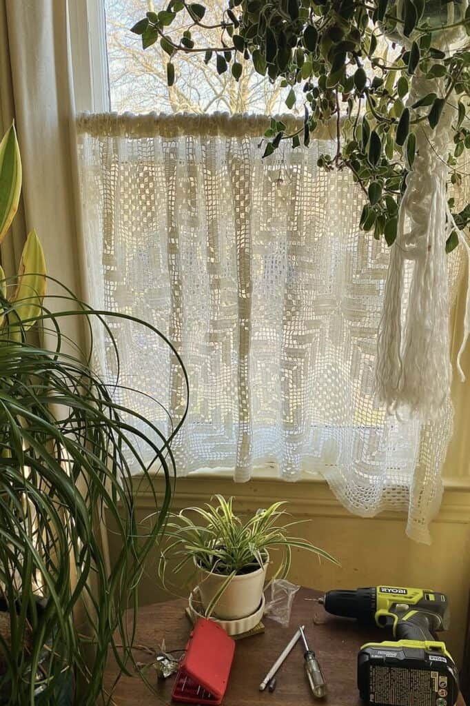 Vintage lace window curtain in home decor scene.