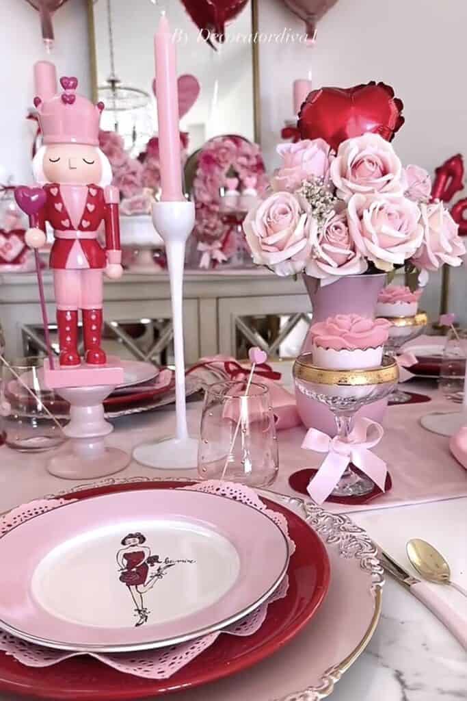 Pink Valentine’s Day table setting with roses and candles.