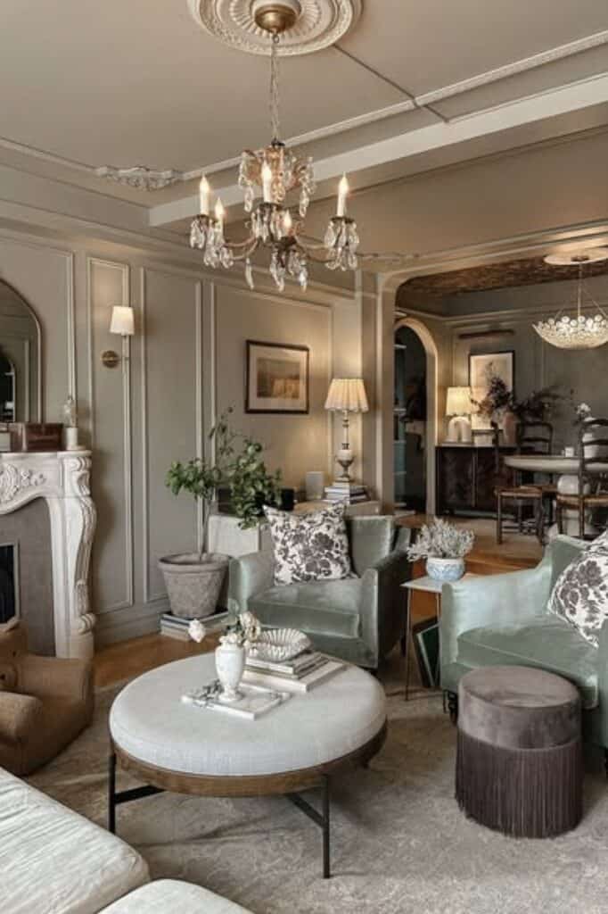 Luxurious living space featuring antique chandelier, plush seating, and classic decor.
