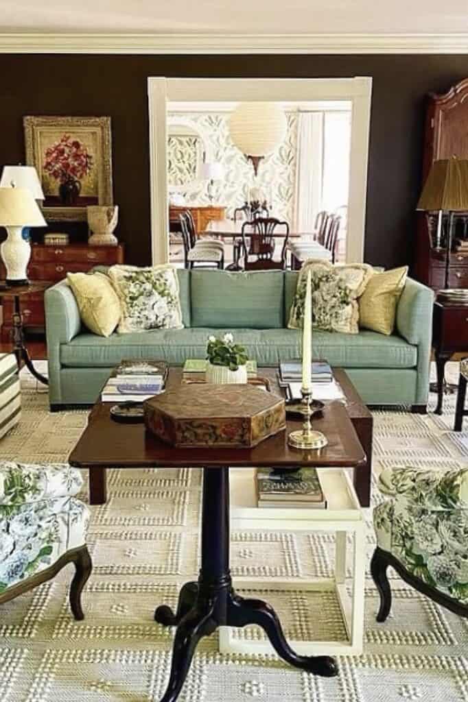 Elegant vintage-style living room with sofa, coffee table, and decorative pillows.