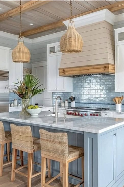 Bright coastal kitchen with white cabinets, blue accents, and natural woven lighting fixtures.