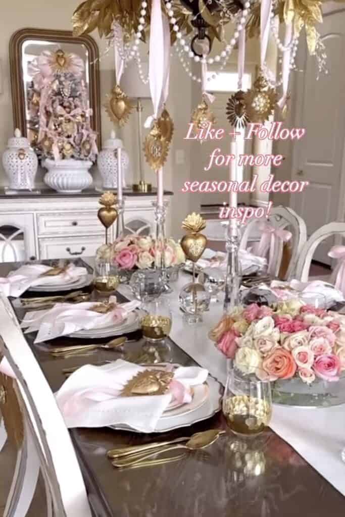 Beautiful decorated dining table with pink roses, gold cutlery, and seasonal floral decor.
