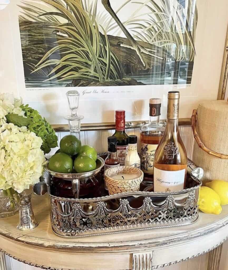 Beautiful bar tray styling with bottles, limes, and decorative accents.