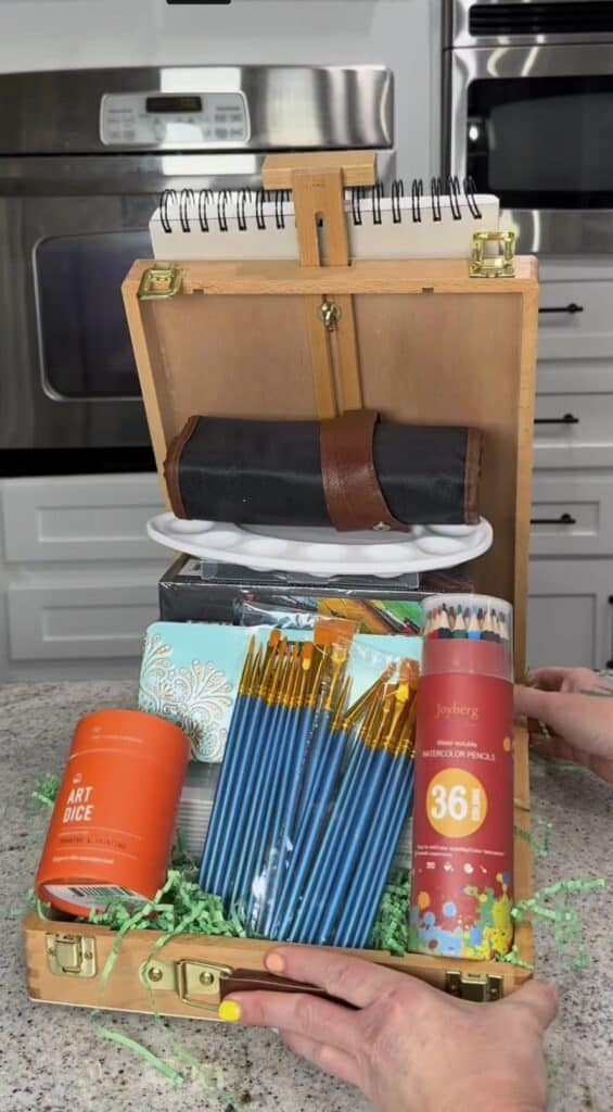 Watercolor pencils and painting supplies arranged artistically