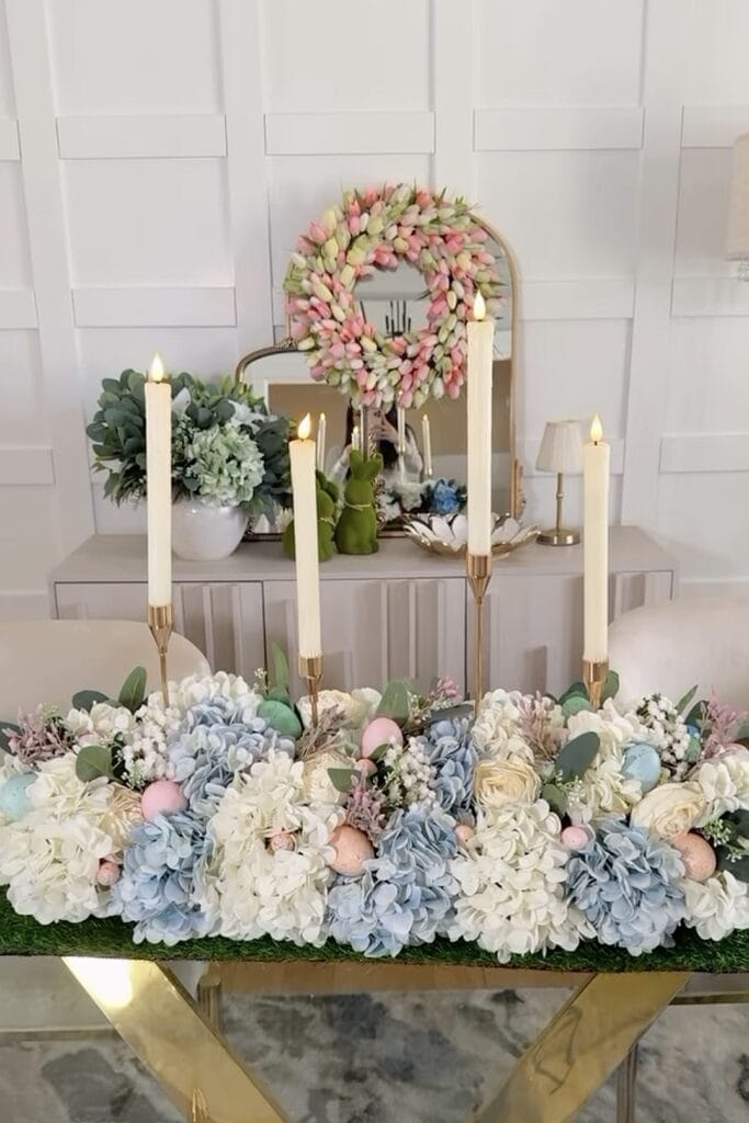 Elegant floral arrangement featuring roses, hydrangeas, and candles for decor.
