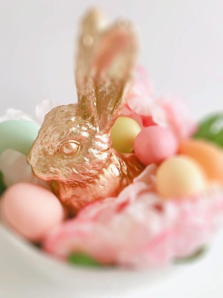 Delicious chocolate bunny surrounded by pastel Easter eggs and pink frosting, perfect for spring cel.