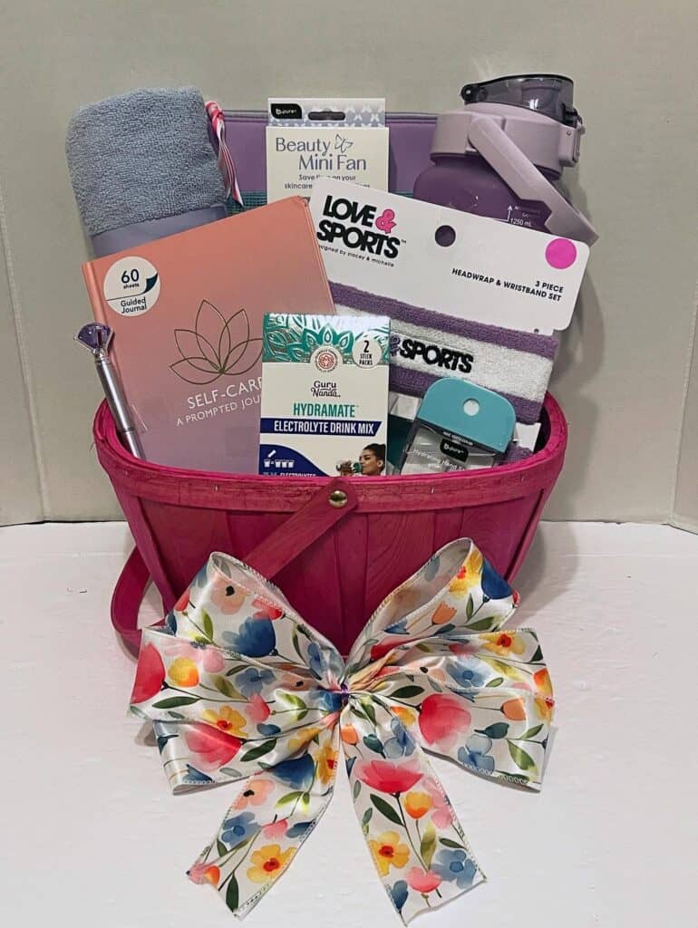 Gift basket with wellness, beauty products, and a colorful bow for Mother's Day.