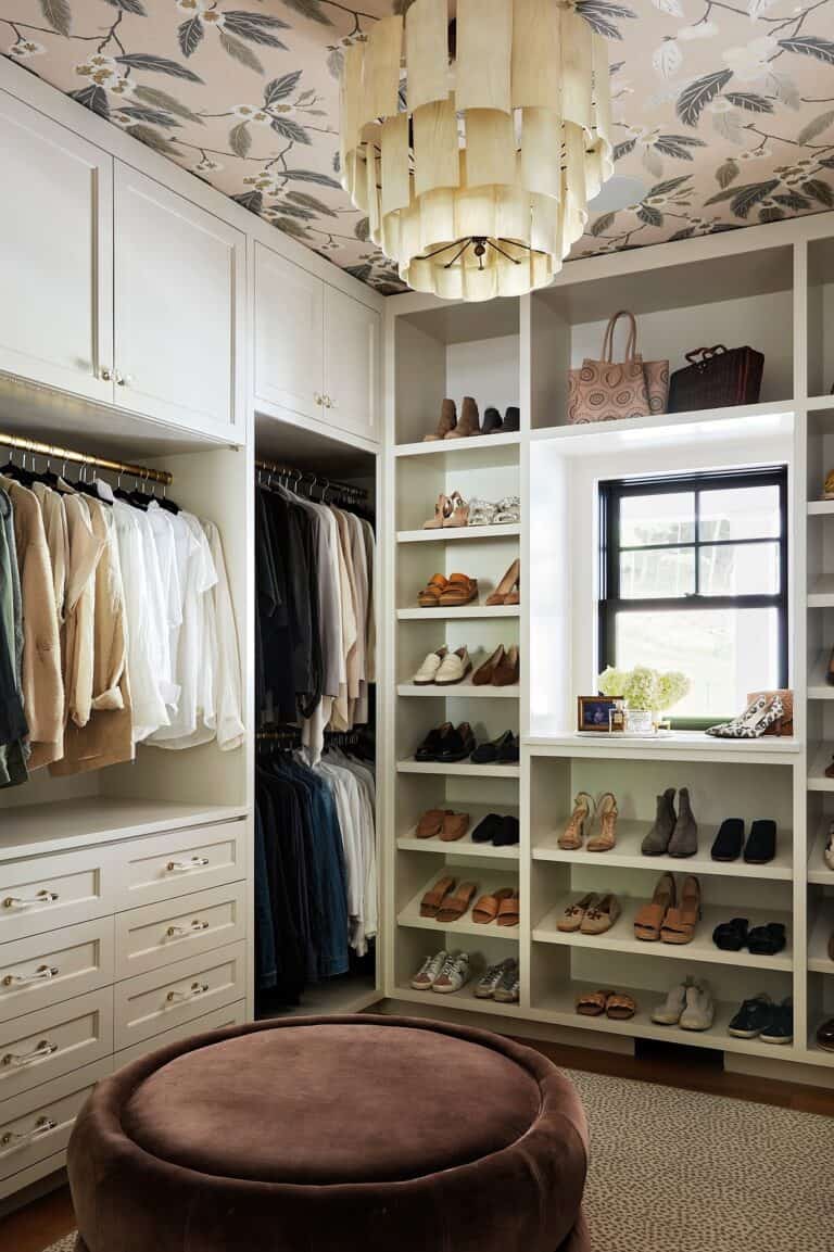 Elegant walk-in closet with custom built-in storage and shoe displays.