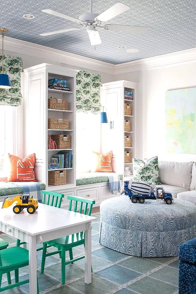Bright playroom with built-in shelves, colorful furniture, and toys.
