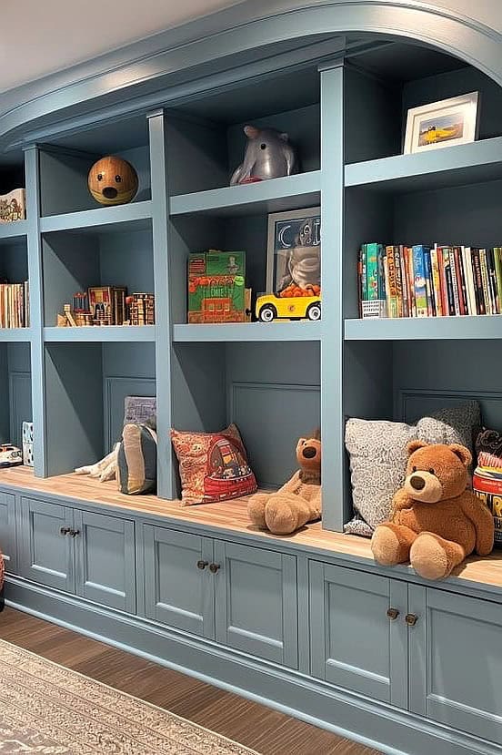 Built-in playroom storage unit with books, toys, and decorative items.
