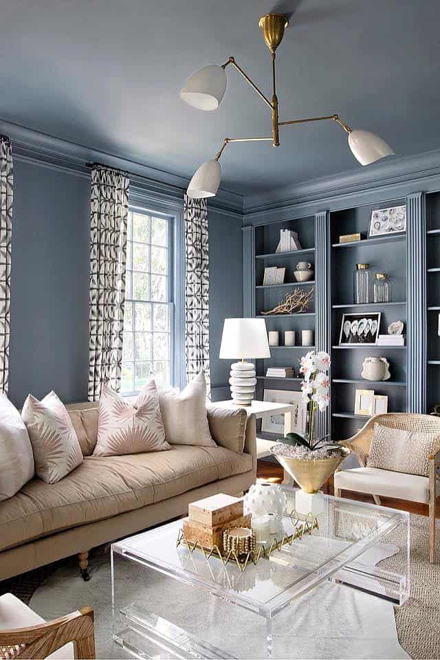 Built-in blue shelves with decor in stylish living room interior.