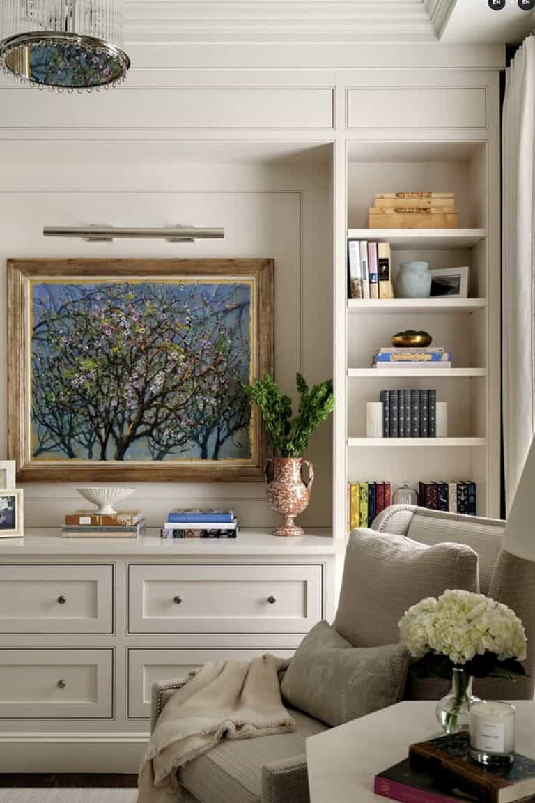 Built-in bedroom storage with artwork, books, and decorative decor.