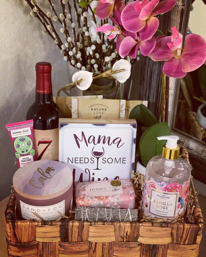Beautiful Mother's Day gift basket with flowers, wine, and skincare products.