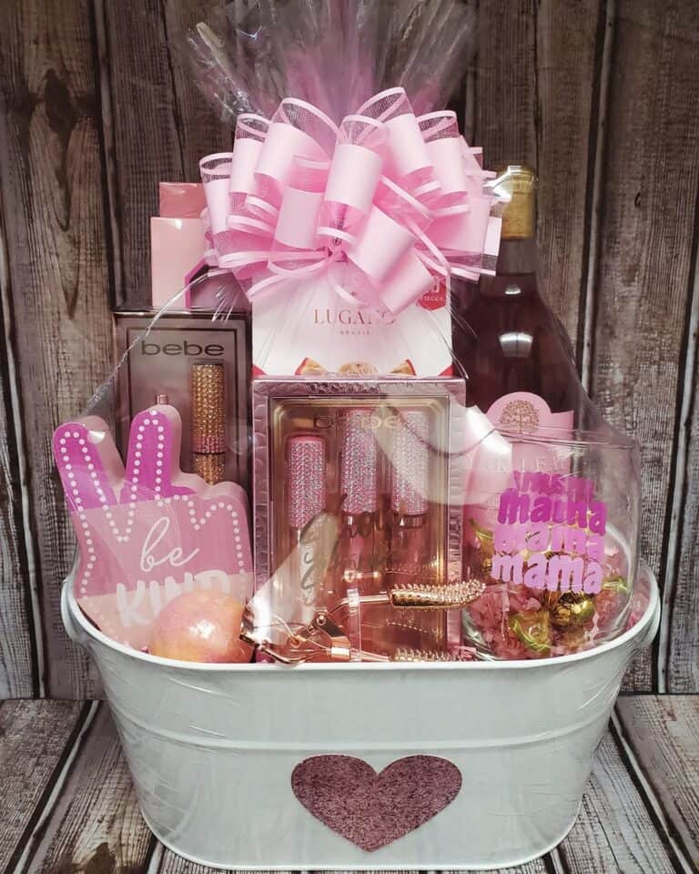 Mother's Day gift basket with pink beauty products, chocolates, and accessories.