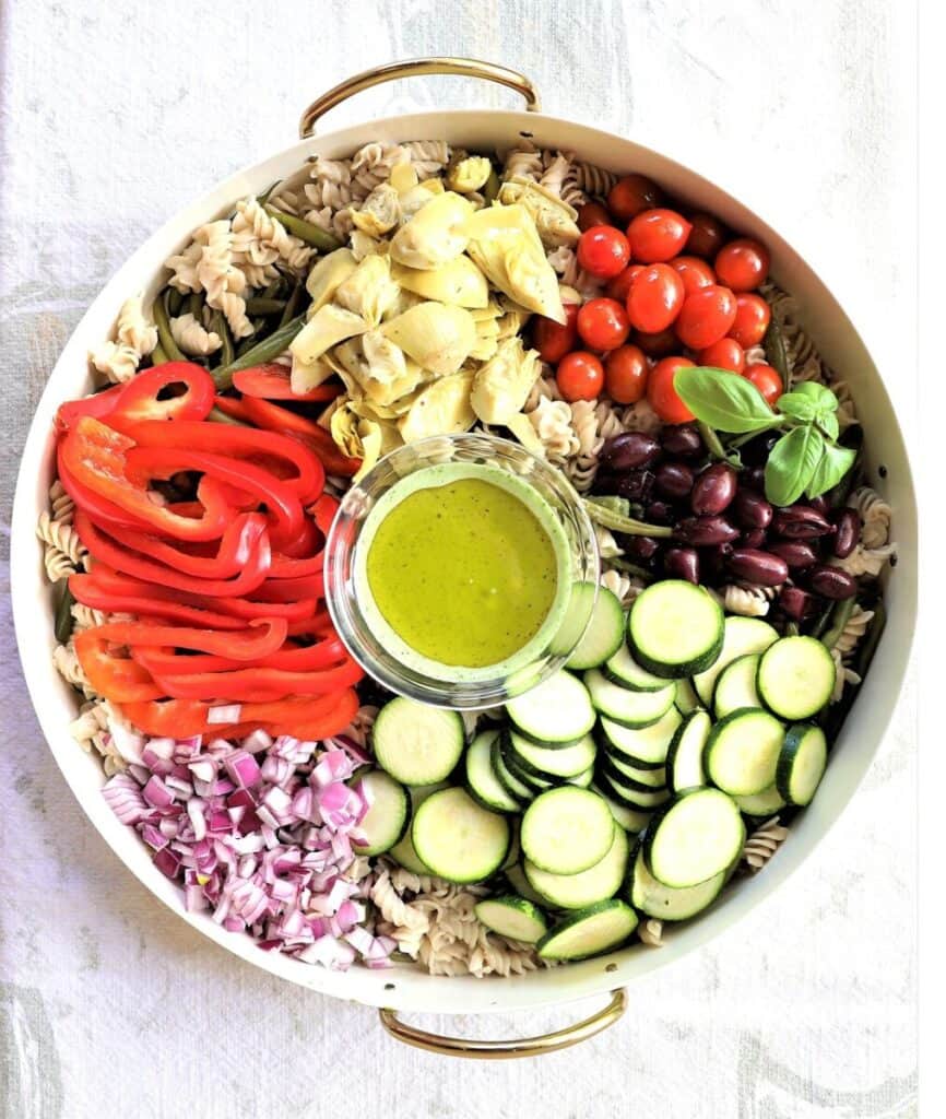 Healthy high-protein salad bowl with colorful vegetables and green dressing.