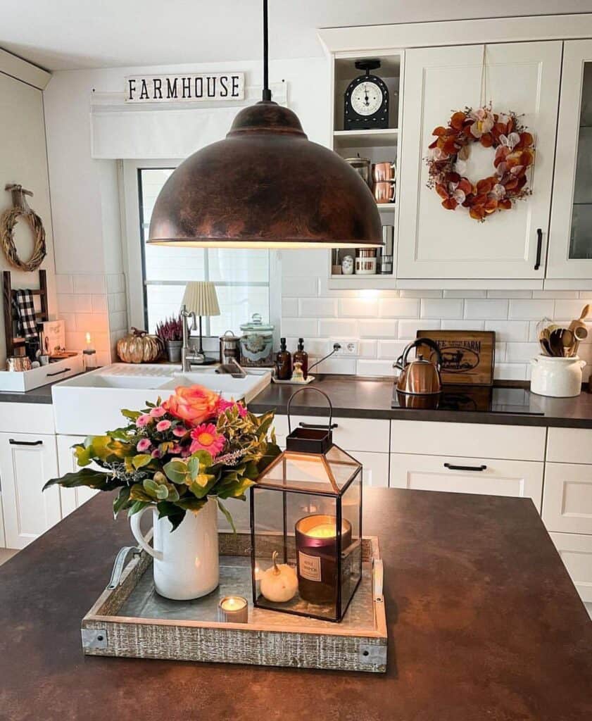 Kitchen table centerpiece with flowers, lantern, and warm decor elements.