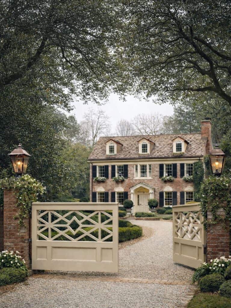 Charming historic house with lush garden and welcoming entrance.