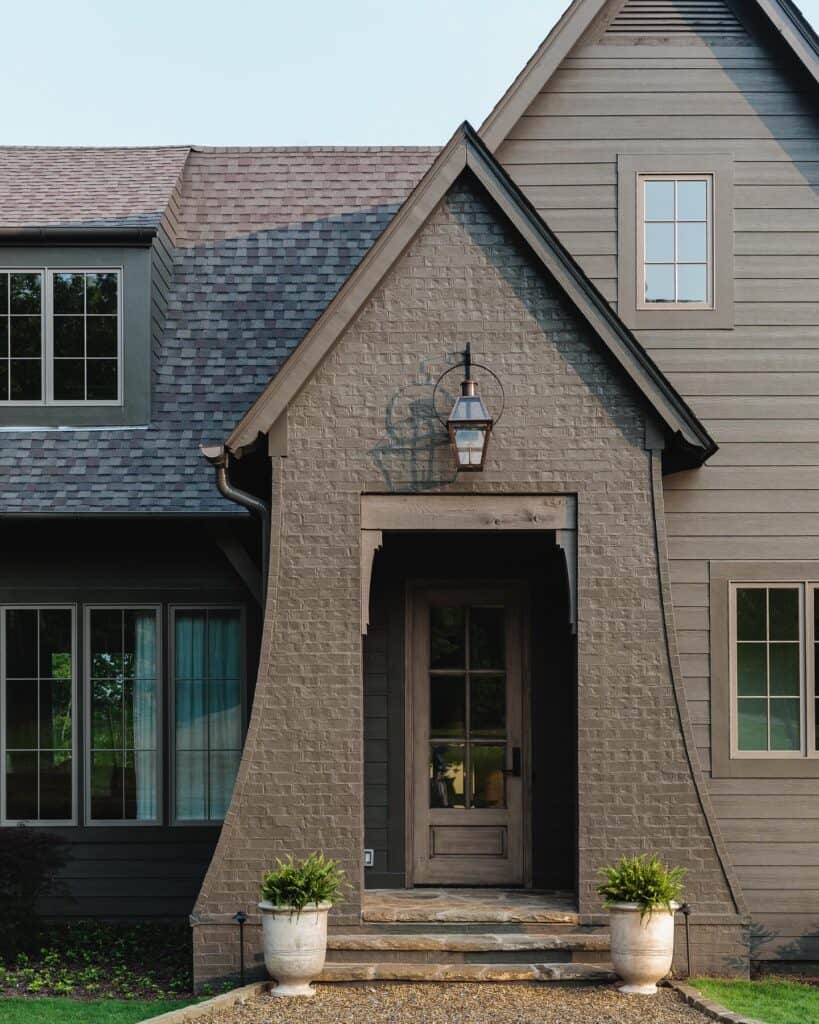 Contemporary house with painted brick facade and front porch.