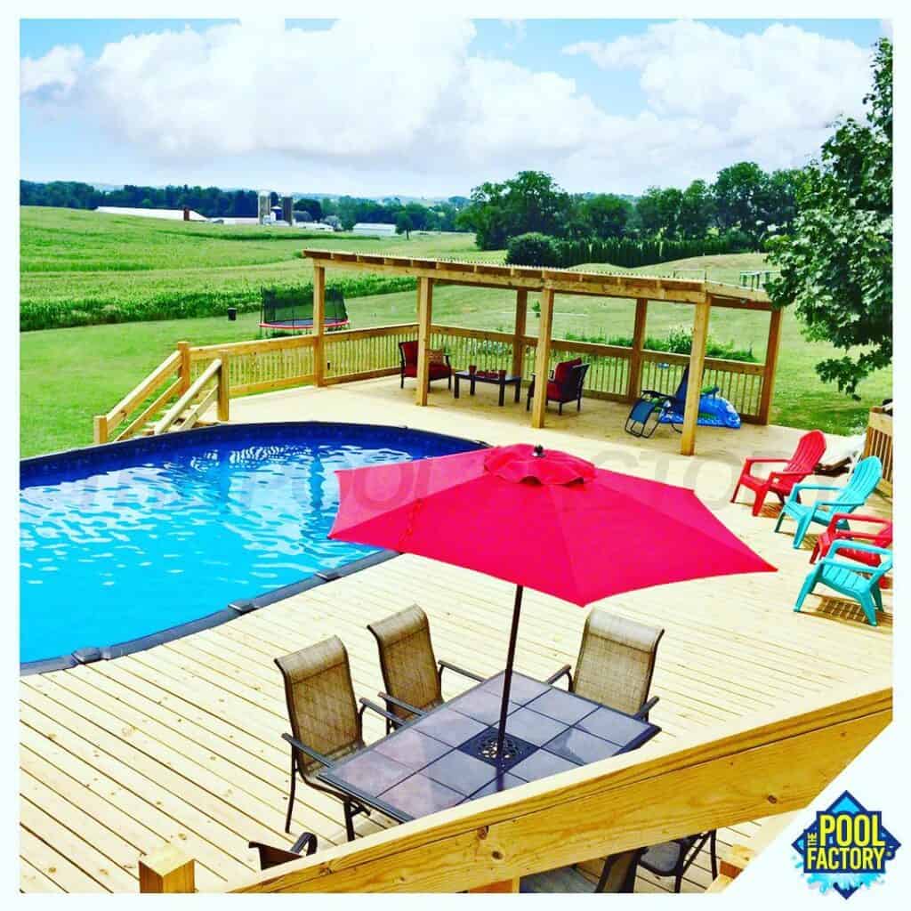 Beautiful backyard with swimming pool, patio furniture, and scenic countryside views.