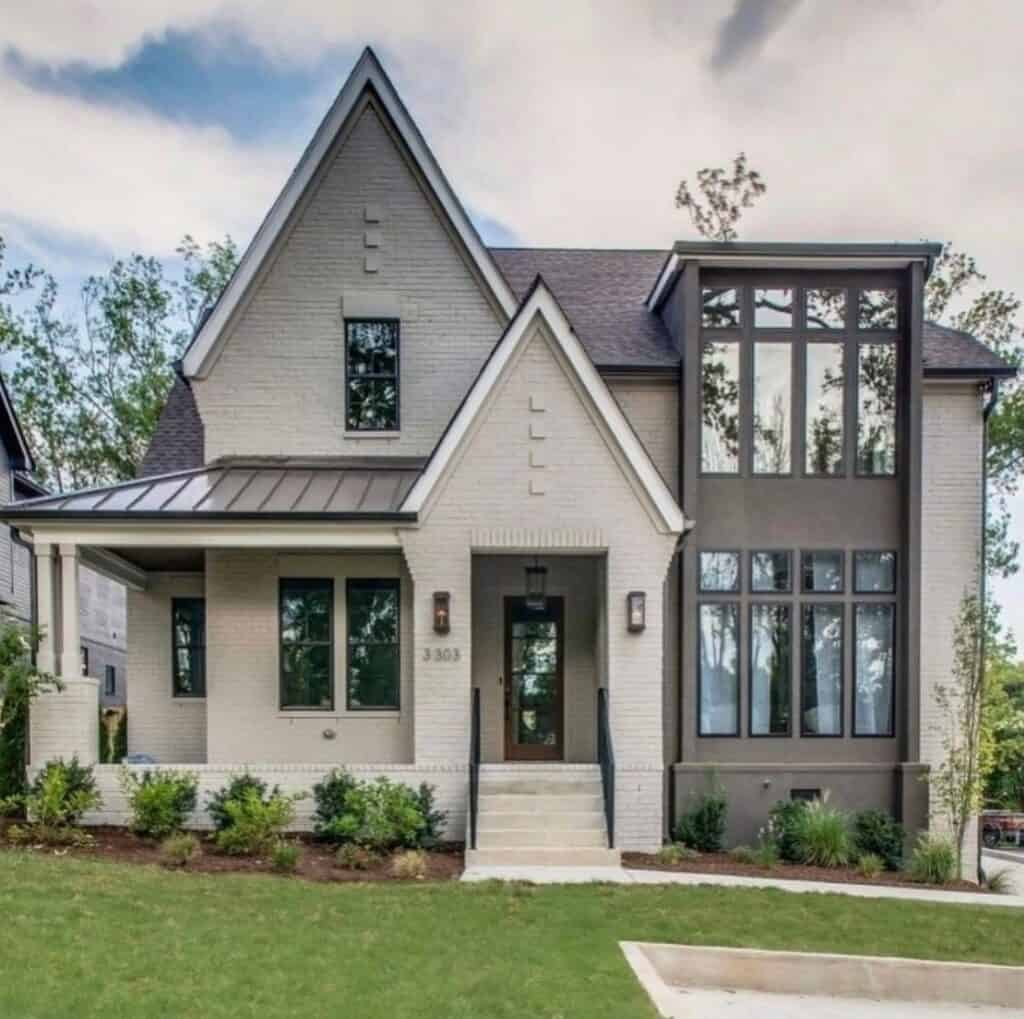 Contemporary house with white and dark gray painted brick exterior.