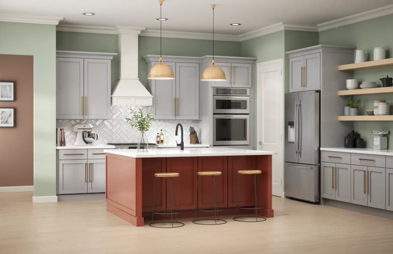 Kitchen with pastel green walls, gray cabinets, and a red island with bar stools.