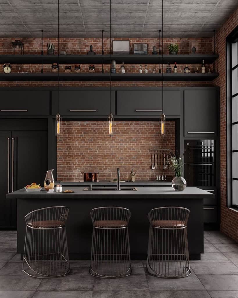Contemporary black kitchen with brick wall, island, and bar stools.