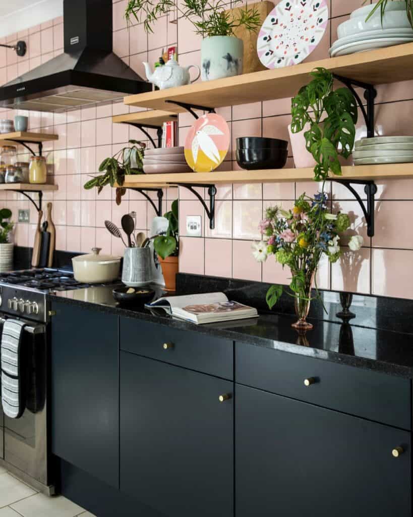 Contemporary black kitchen cabinets with open wooden shelves and decorative items.