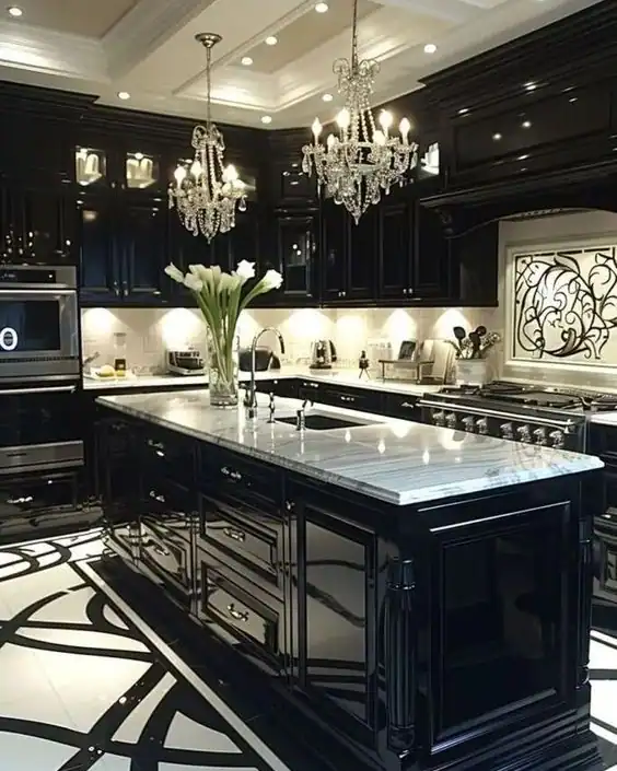 Luxurious black kitchen with marble island, chandeliers, and ornate details.