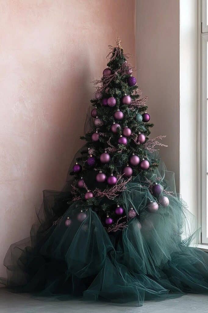 Elegant purple Christmas tree decorated with purple ornaments and tulle skirt.