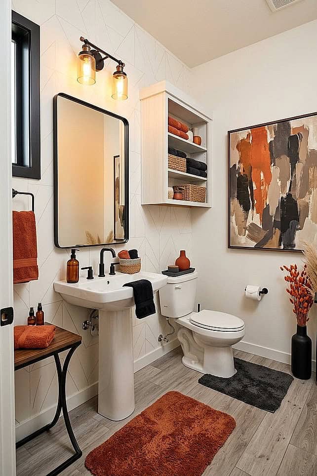 Cozy bathroom with warm orange accents, artwork, and rustic decor for fall.