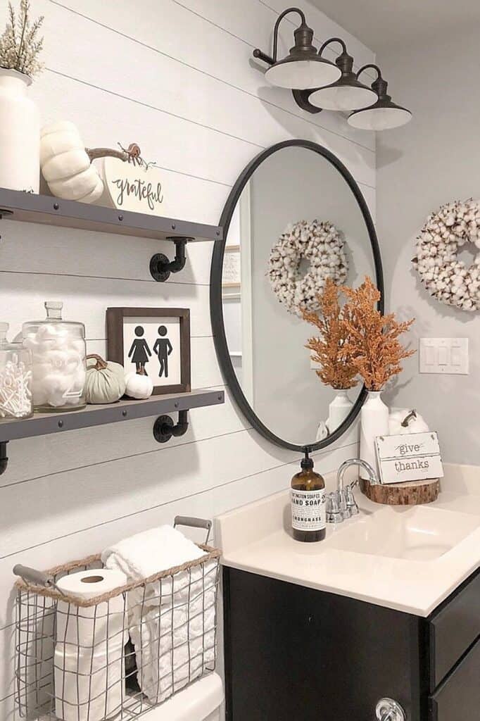 Bathroom with fall-themed decor, wreaths, and neutral tones for autumn.