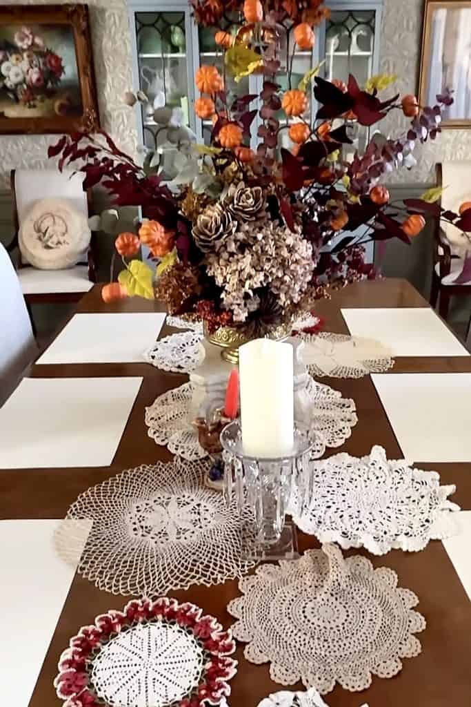 Beautiful floral arrangement with doilies on a dining table for home decor.