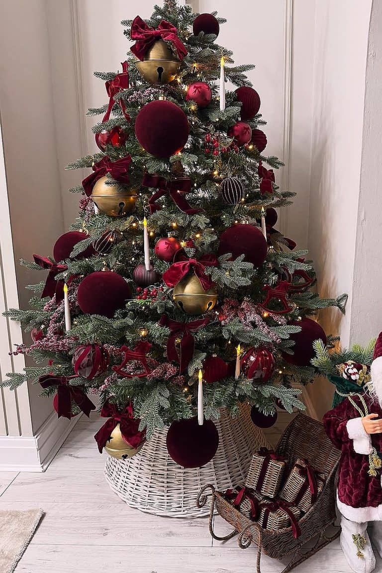 Christmas tree decorated with burgundy and gold ornaments for holiday decor.