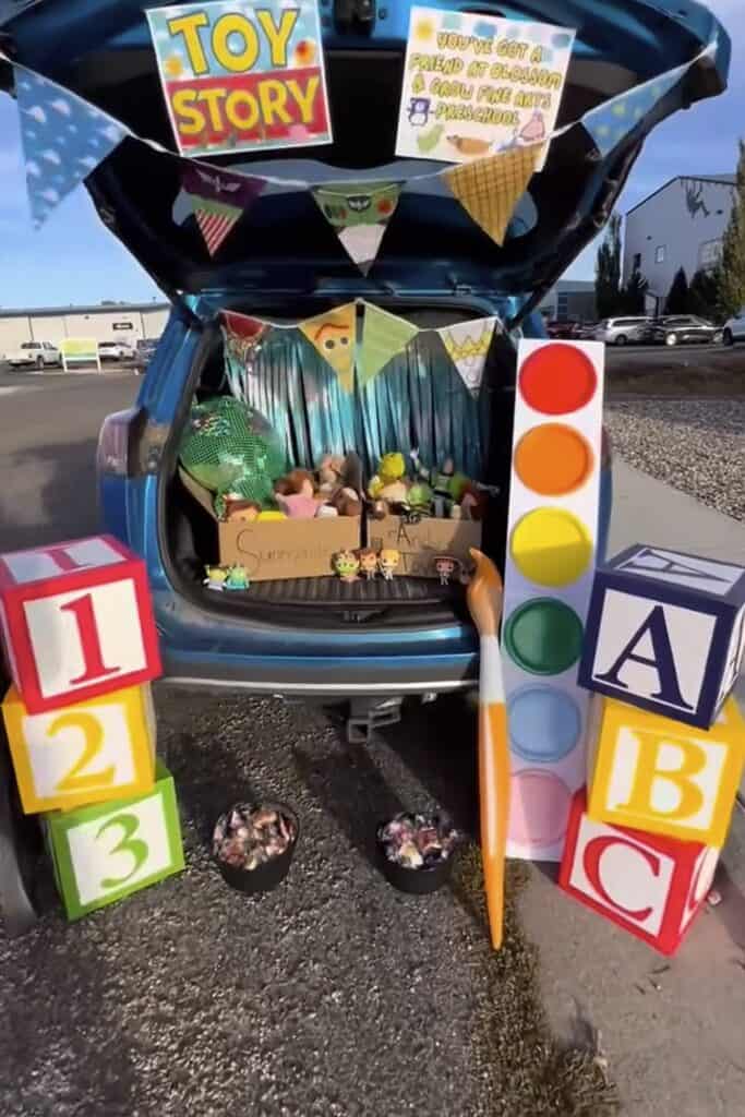 Toy Story themed trunk or treat setup with blocks, toys, and decorations.