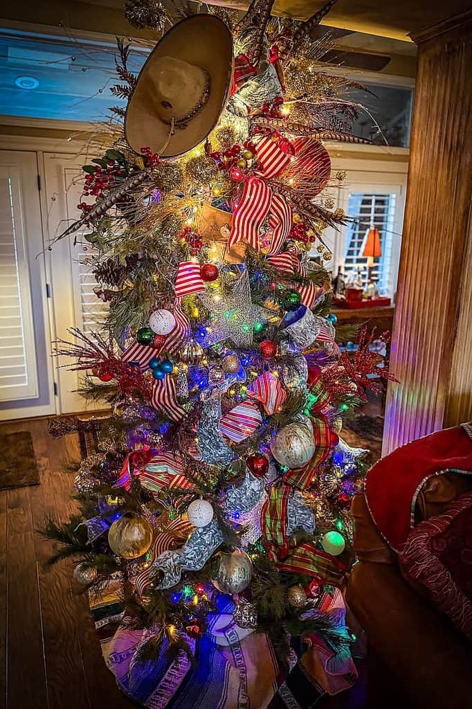 Decorated Christmas tree with hats, ribbons, ornaments, and colorful lights.