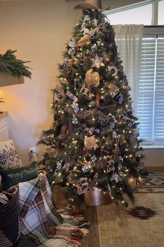 Festive Christmas tree decorated with gold and silver ornaments and lights in a cozy home.