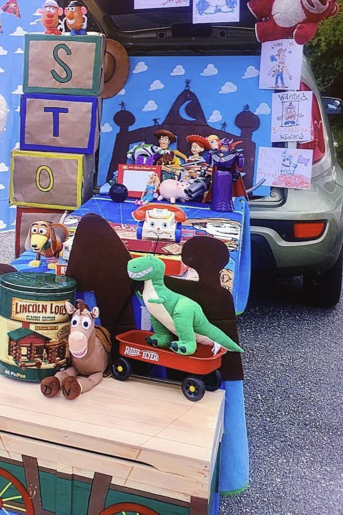 Toy Story themed trunk or treat setup with plush characters and blocks.