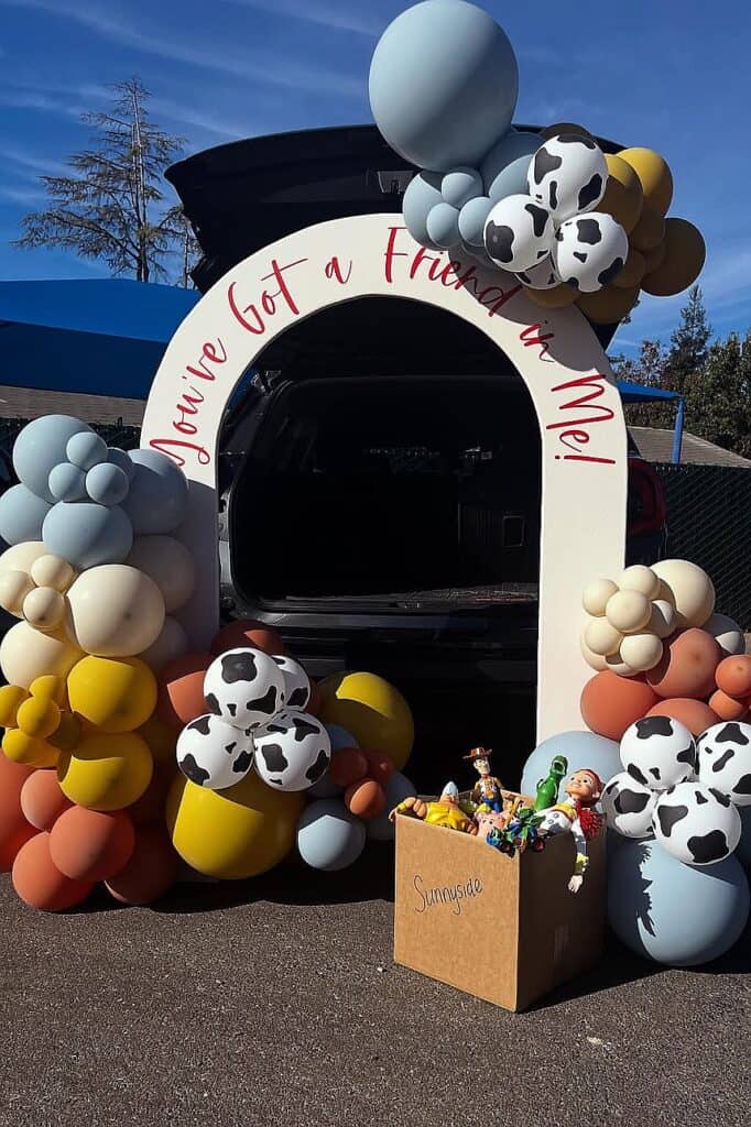 Toy Story themed trunk or treat setup with balloons and characters.