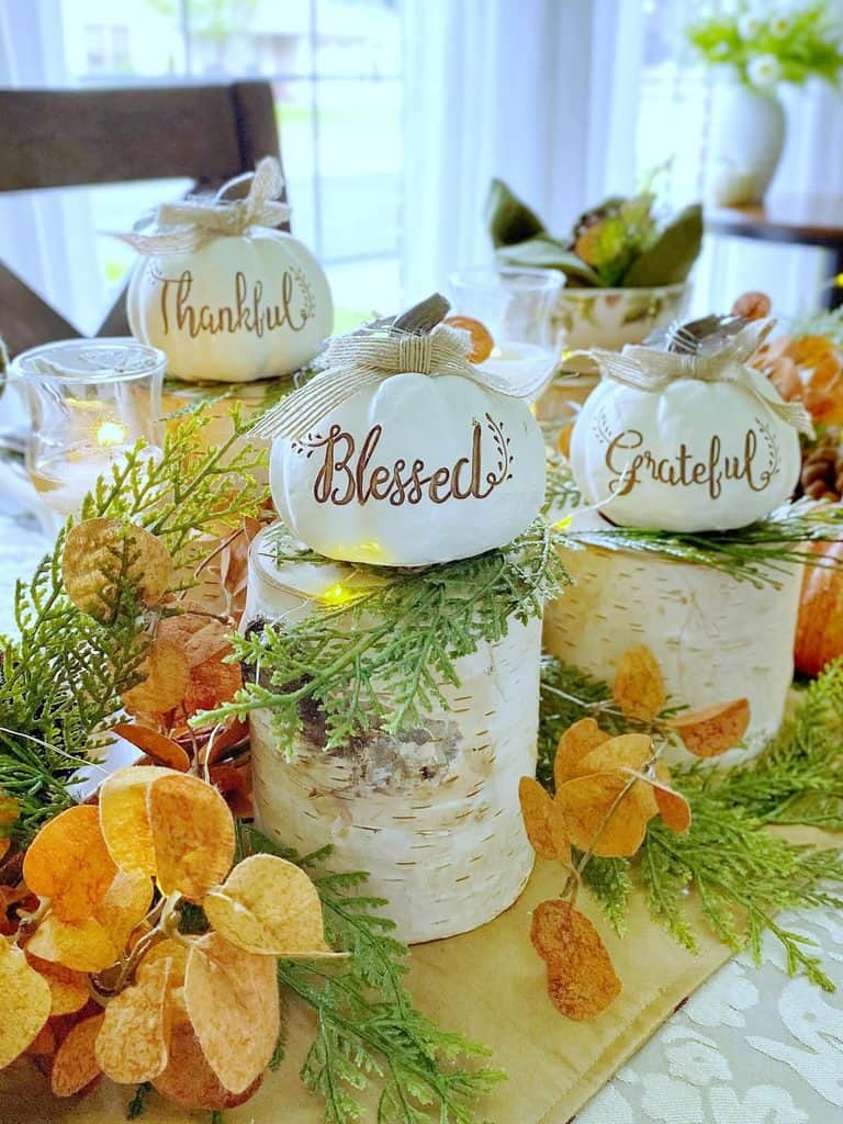Autumn pumpkin decorations with thankful, blessed, and grateful tags for fall decor.