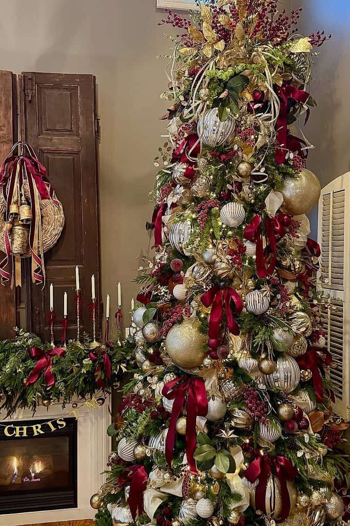 Beautiful Christmas tree decorated with burgundy ribbons and silver ornaments.
