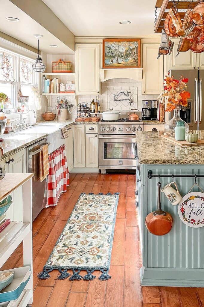 Fall-themed kitchen with orange and blue decor, pumpkins, and autumn flowers.